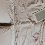 Top view of a cozy bed with an ebook reader on soft sheets, perfect for relaxed reading enthusiasts.